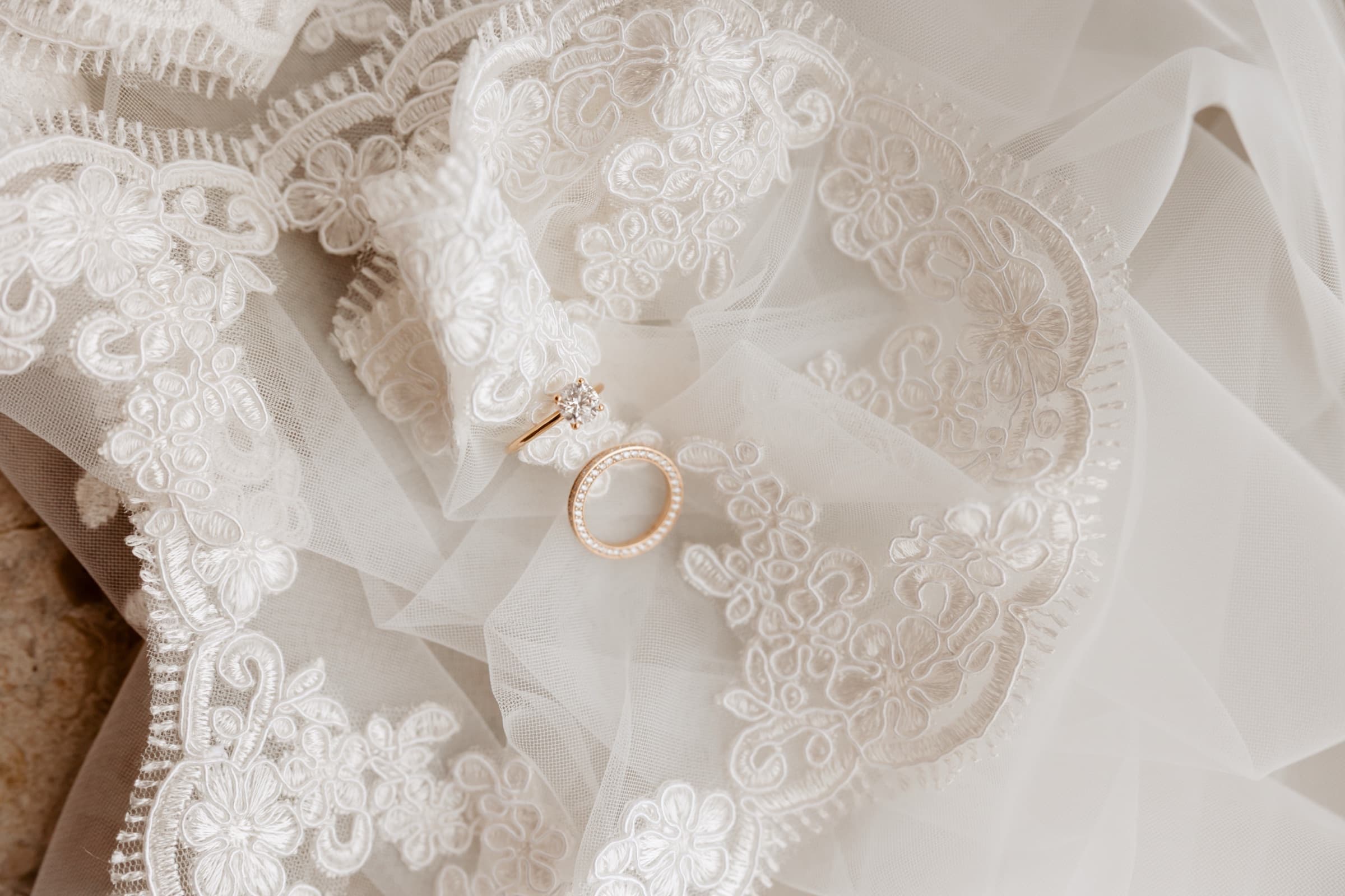 Engagement ring resting on bridal lace