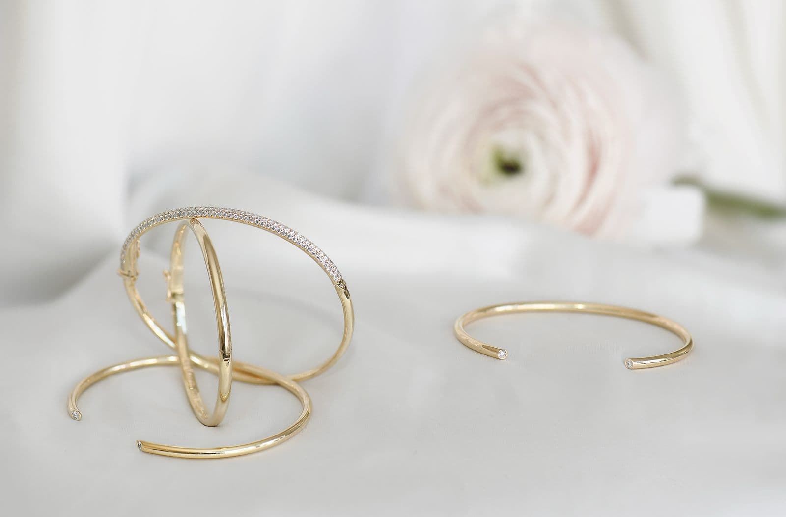 Stacked gold cuffs with pavé diamond detail