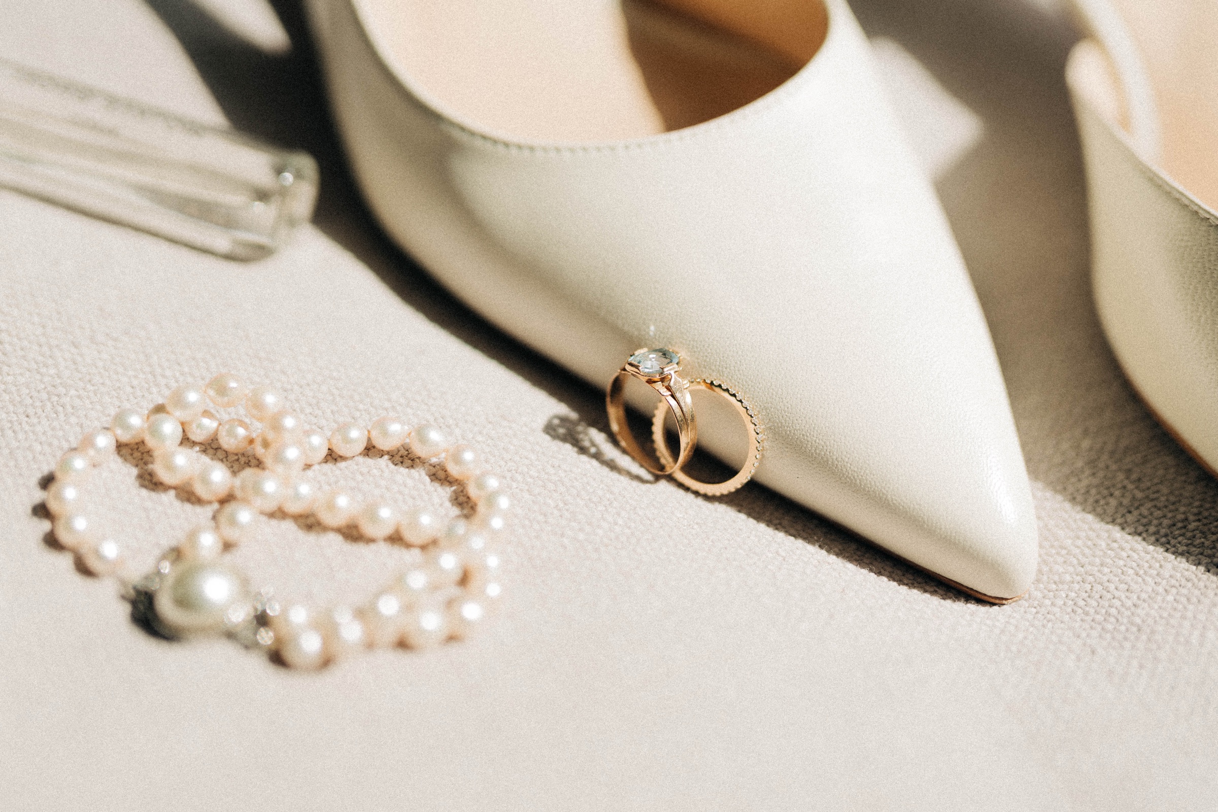 Engagement rings — round, oval, and emerald — set out on a velvet bridal still life