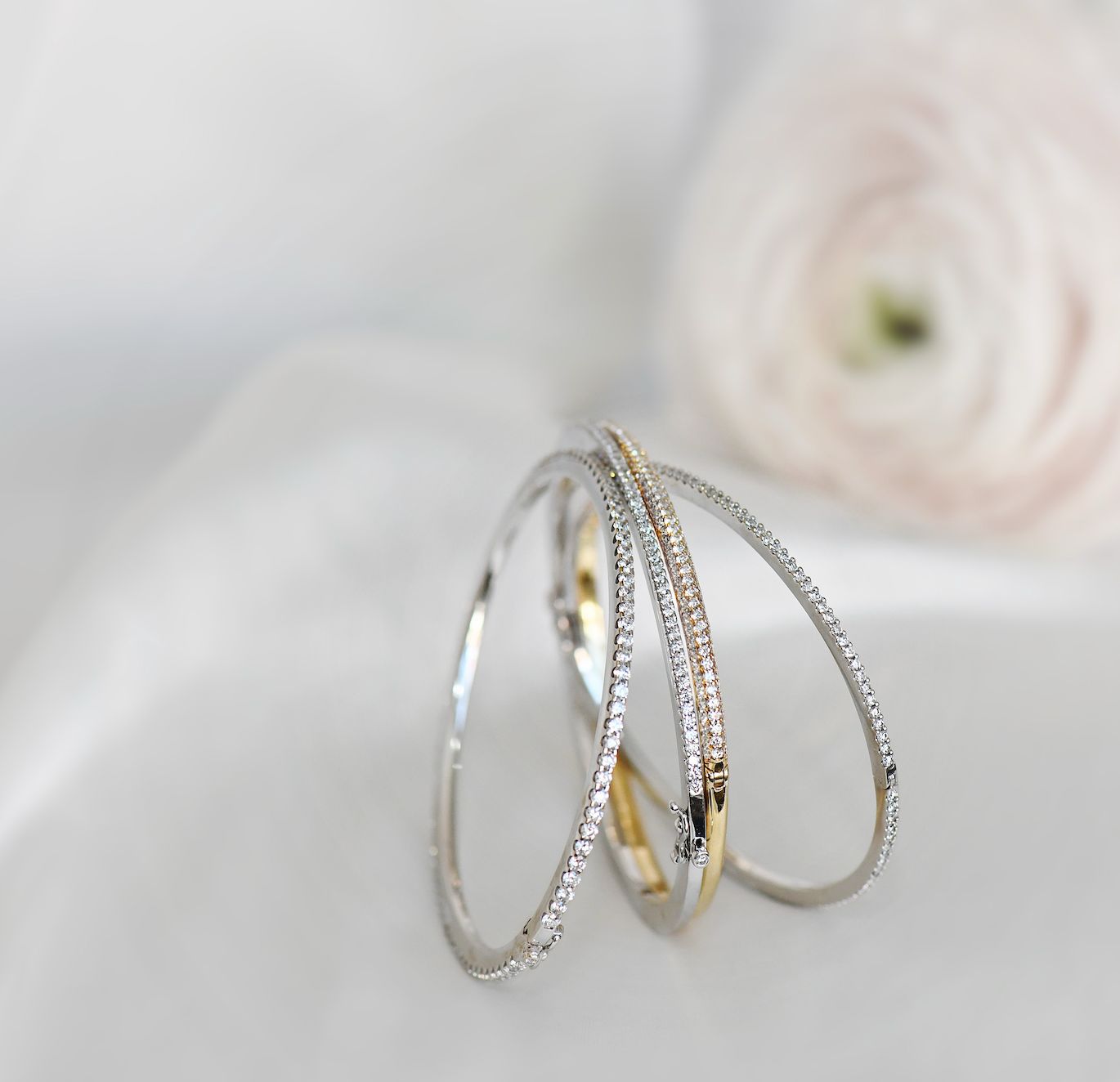 Three pavé diamond bangles in white and yellow gold